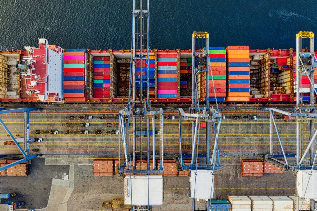 Aerial view of colorful cargo containers at a bustling port in Jakarta, Indonesia.